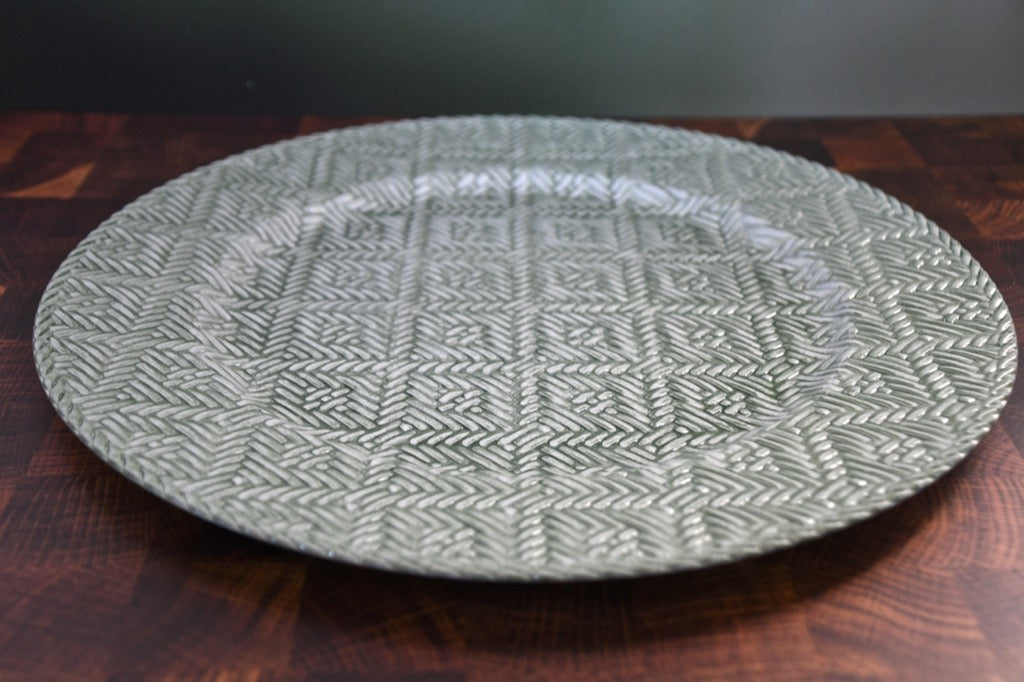 Round woven placemat on a wooden surface
