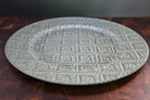 Round woven placemat on a wooden surface