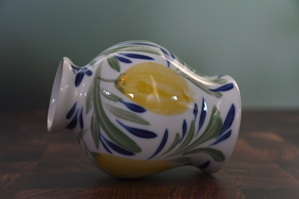 Decorative ceramic vase with floral patterns on a wooden surface