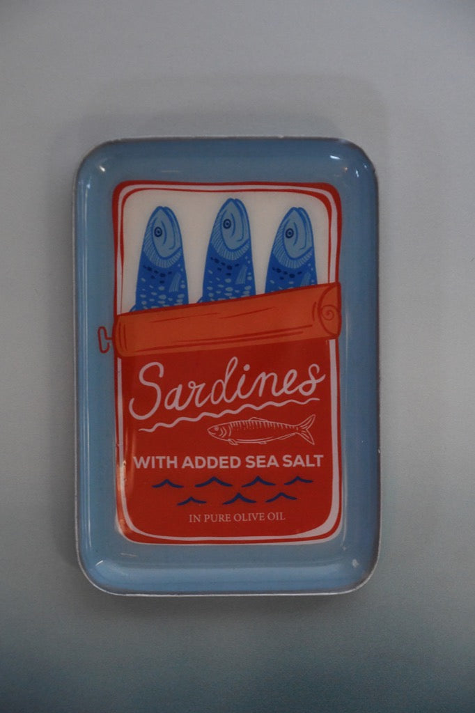 Sardine can with blue label and red label on a gray background