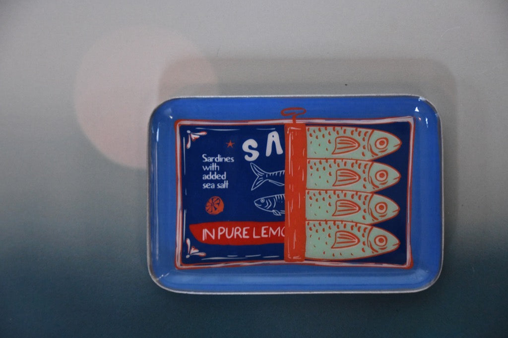 Blue tray with fish design and text on a gray background