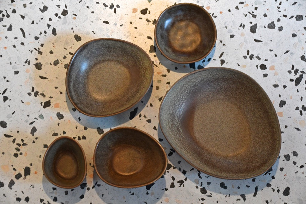 Set of ceramic plates on a speckled surface