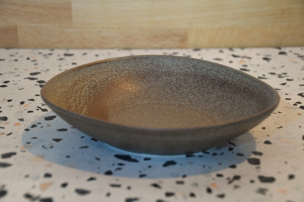 Decorative bowl on a speckled countertop