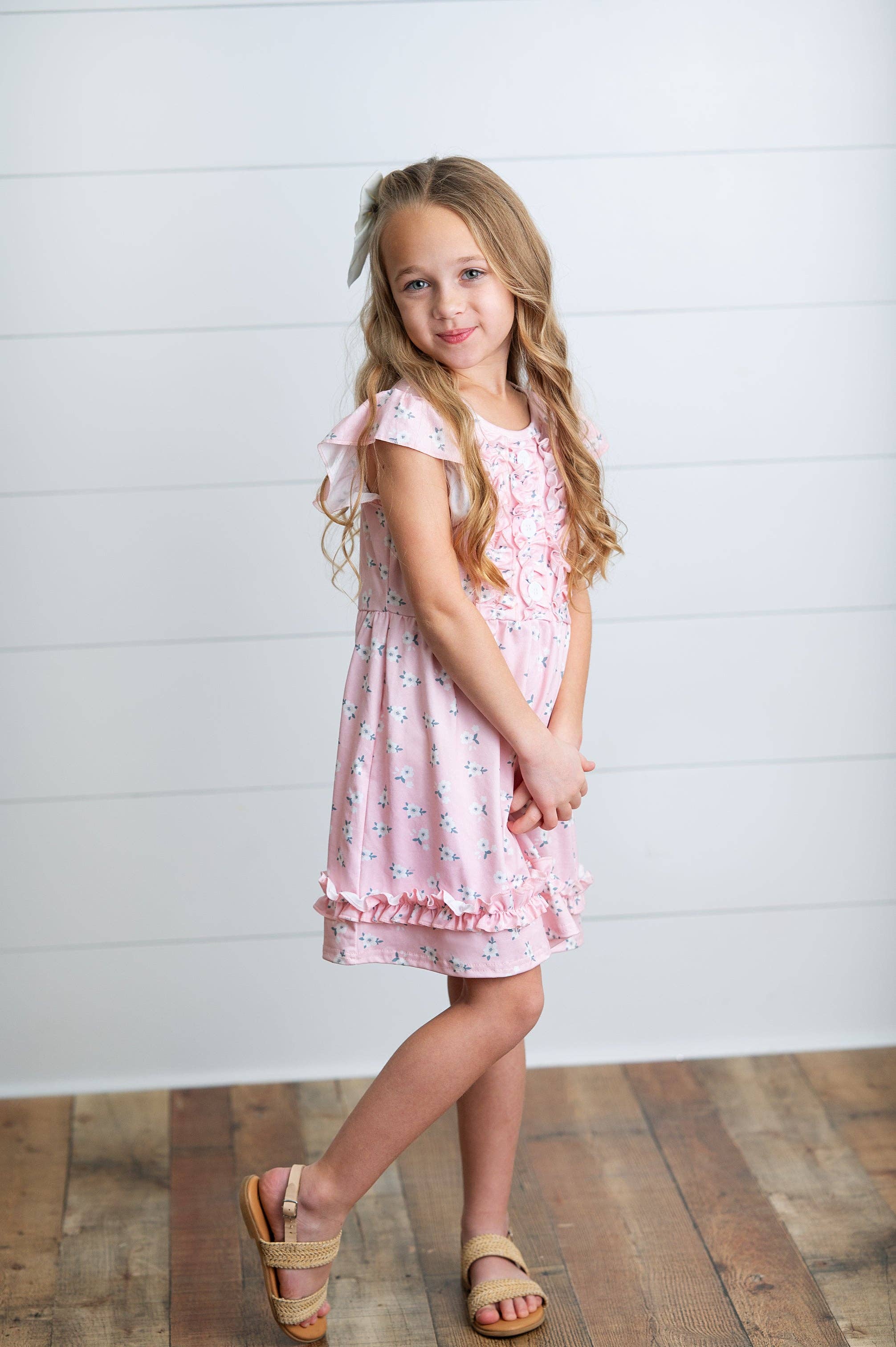 Girls Pink dress with buttons ruffles and flowers. 