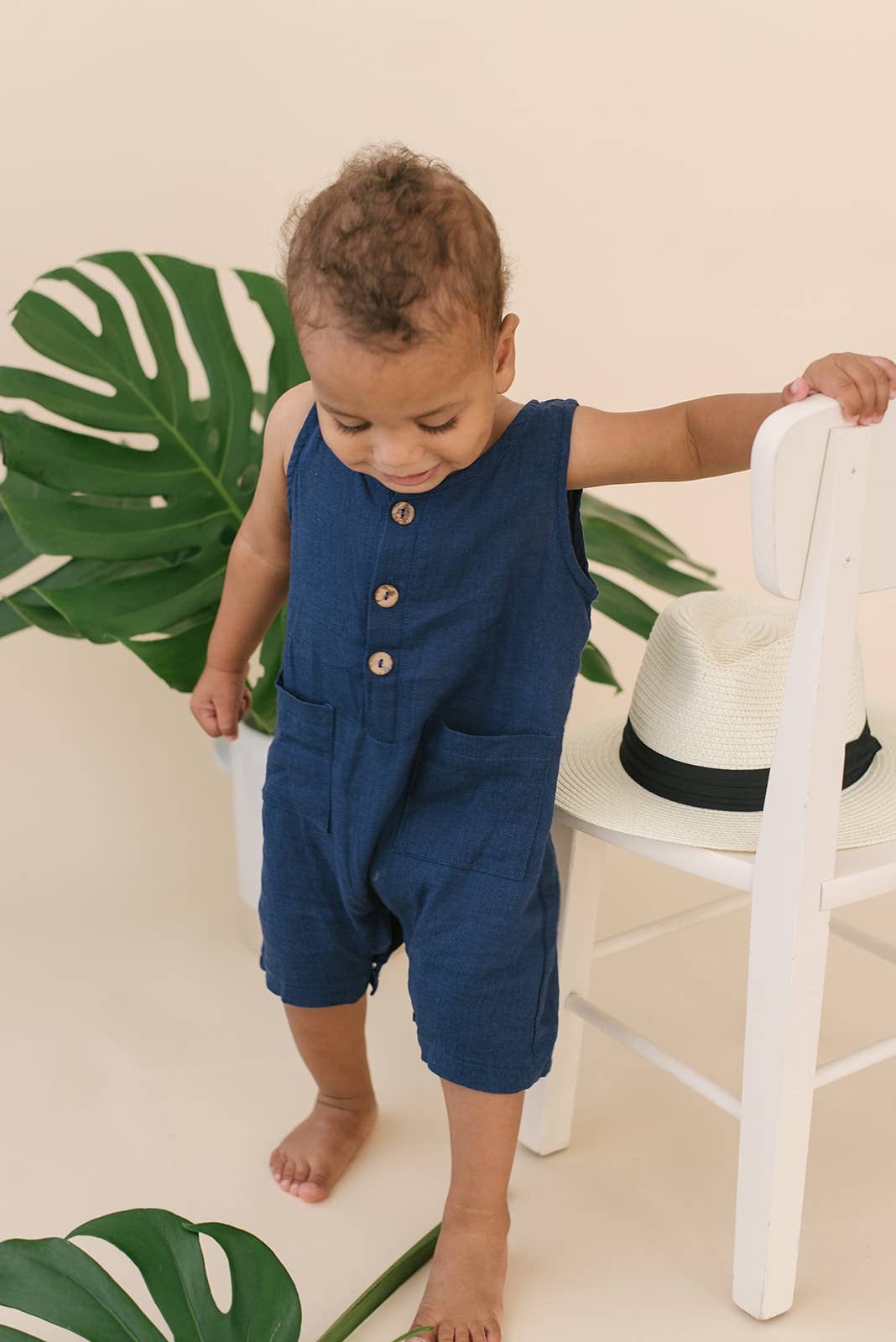 Toddler baby romber in navy blue with front pockets and buttons