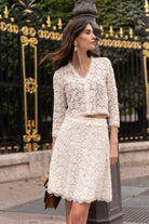 Ivory lace midi skirt. Hits above knee and features floral lace.