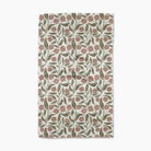 Floral patterned towel with pink flowers and green leaves on a white background