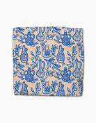 Patterned fabric with blue designs on a beige background