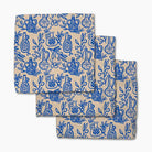 Set of folded towels with blue bottle pattern on a beige background