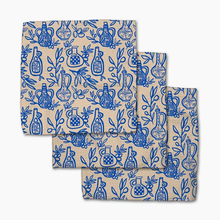 Set of folded towels with blue bottle pattern on a beige background