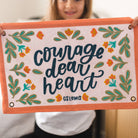 Canvas banner that says courage dear heart. C.S. Lewis quote