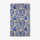 Beige towel with blue pattern of bottles and leaves on a white background