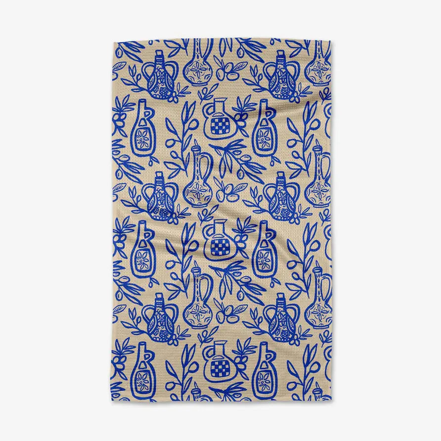 Beige towel with blue pattern of bottles and leaves on a white background