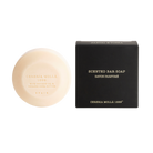 Bar of soap and its packaging on a white background
