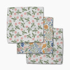 Set of three floral-patterned cloths on a white background