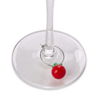 Wine glass charm shaped like a red apple on a white background